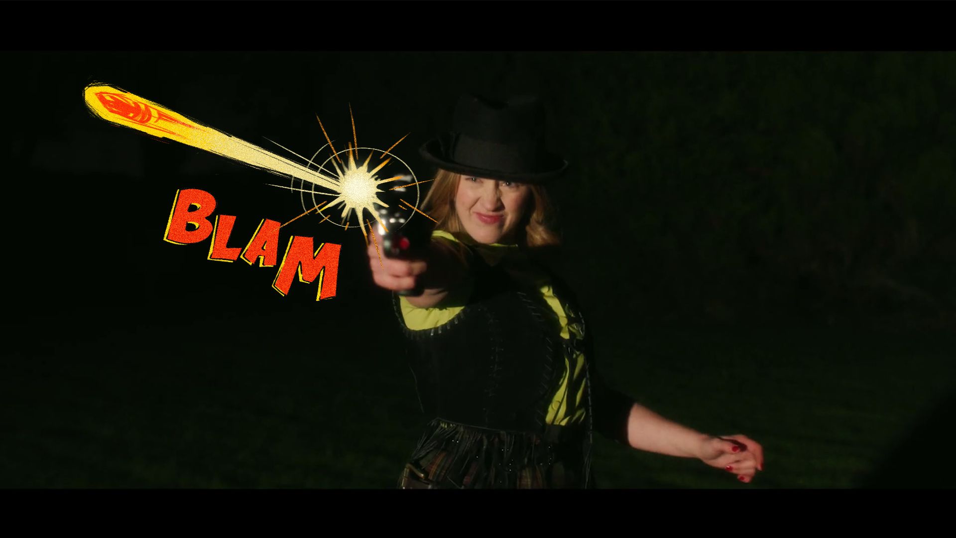 A dark night scene of a smiling person in a black hat and corset pointing a small black gun at the camera; a yellow cartoon energy blast streaks from the muzzle with a starburst impact effect, and large red comic-style lettering reads 'BLAM' to the left